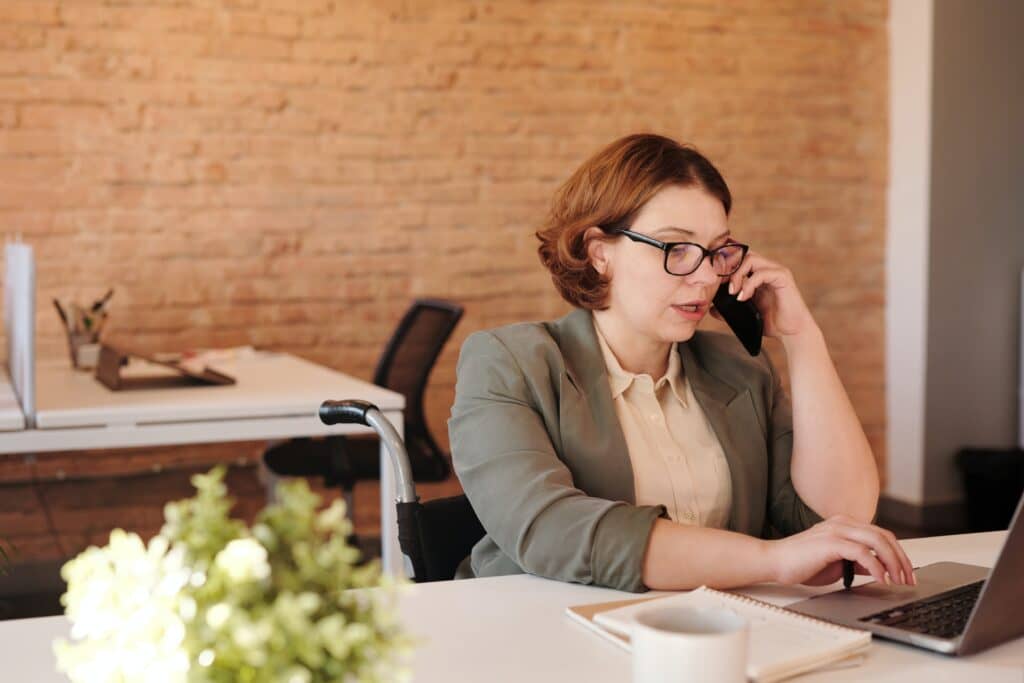 woman calling someone while using her phone