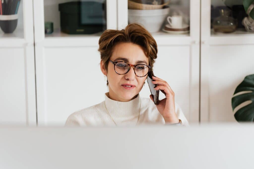 woman calling someone with her phone