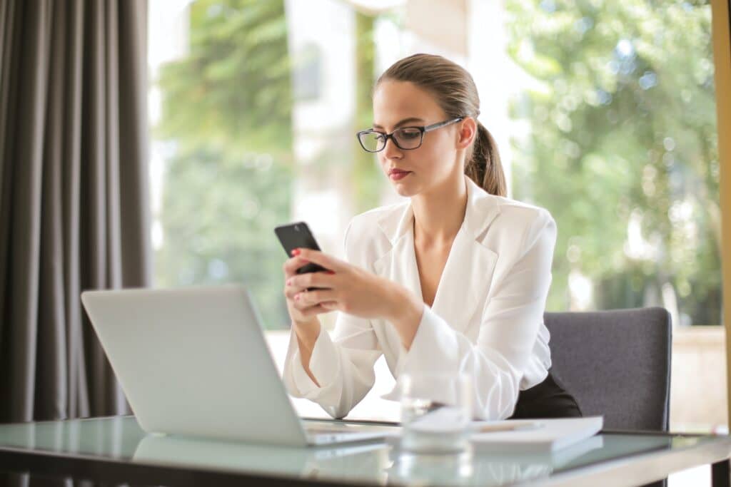 woman using her phone while working