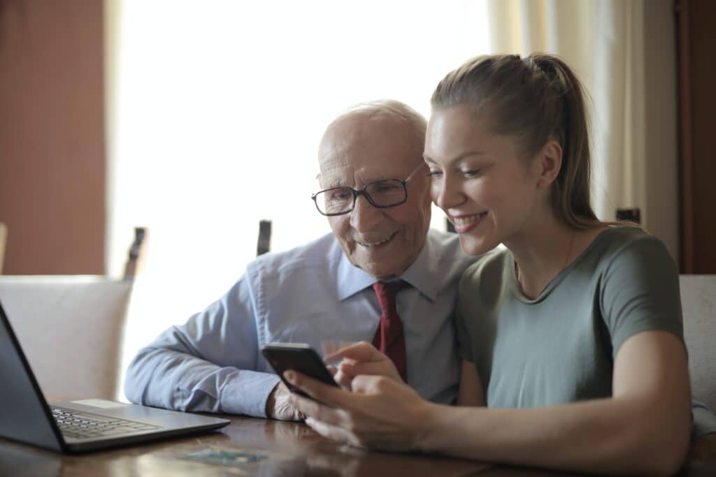 woman showing her phone to older man